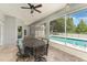 Enclosed patio features a dining area with view of private pool, perfect for outdoor entertaining at 1610 Sherwood Lakes Blvd, Lakeland, FL 33809
