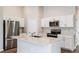 Modern kitchen with stainless steel appliances, white cabinets, and a center island at 4011 Gardenia Ave, Lake Hamilton, FL 33851