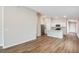 Open-concept living space with wood floors connected to a modern kitchen at 4011 Gardenia Ave, Lake Hamilton, FL 33851
