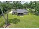Aerial view of home and yard, showcasing manicured lawn and screened porch, highlighting outdoor living at 5080 Maple Dr, Lakeland, FL 33810