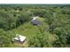 Expansive property showcasing house, outbuilding, and ample green space, set in a serene, wooded environment at 5080 Maple Dr, Lakeland, FL 33810
