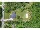 Aerial view of home on large lot featuring expansive lawn, mature trees, and concrete driveway at 5080 Maple Dr, Lakeland, FL 33810