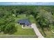 Expansive aerial view of property featuring a spacious lot, wooden fencing, and mature trees at 5080 Maple Dr, Lakeland, FL 33810
