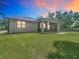 Backyard view showcasing the screened porch, expansive lawn, and privacy at 5080 Maple Dr, Lakeland, FL 33810