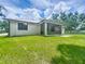 Expansive backyard featuring a screened porch perfect for outdoor relaxation and entertainment at 5080 Maple Dr, Lakeland, FL 33810