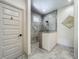 Bathroom featuring gray tiled walk-in shower with glass surround and gray tiled floors at 5080 Maple Dr, Lakeland, FL 33810