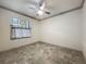 Comfortable bedroom with a ceiling fan, neutral walls, and marble flooring at 5080 Maple Dr, Lakeland, FL 33810