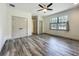 Bedroom with a large closet, laminate wood flooring, and natural light at 5080 Maple Dr, Lakeland, FL 33810