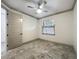 Cozy bedroom featuring a ceiling fan, natural light, and classic paneled doors at 5080 Maple Dr, Lakeland, FL 33810