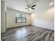 Bedroom with modern wood floors, natural light, and overhead fan at 5080 Maple Dr, Lakeland, FL 33810