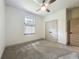 Cozy bedroom featuring plush carpet, a ceiling fan, double closet and plenty of natural light at 5080 Maple Dr, Lakeland, FL 33810