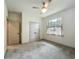 Bedroom with large closet, ceiling fan, and natural light overlooking the yard at 5080 Maple Dr, Lakeland, FL 33810