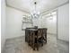 Dining area features a modern chandelier, adjacent to a door leading to the entry way and other rooms at 5080 Maple Dr, Lakeland, FL 33810