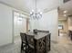 Open dining area with decorative table and chandelier, adjacent to the kitchen and open entryway at 5080 Maple Dr, Lakeland, FL 33810