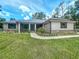Attractive home with a well-maintained lawn and decorative landscaping around the front entrance at 5080 Maple Dr, Lakeland, FL 33810