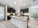 Modern kitchen with stainless steel appliances, granite countertops, and stylish black cabinetry at 5080 Maple Dr, Lakeland, FL 33810