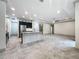 Open concept kitchen with granite island, stainless steel appliances, and an adjacent living area at 5080 Maple Dr, Lakeland, FL 33810