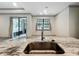 Kitchen island featuring granite counters, stainless steel appliances, and modern faucet fixture at 5080 Maple Dr, Lakeland, FL 33810
