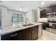 Stylish kitchen island with granite counters, stainless steel appliances, and black and white cabinetry at 5080 Maple Dr, Lakeland, FL 33810