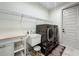 Laundry room with front-loading washer and dryer, sink, butcher block counter and wire shelving at 5080 Maple Dr, Lakeland, FL 33810