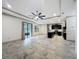 Spacious living room adjacent to kitchen and patio featuring recessed lighting, ceiling fan, and tile floors at 5080 Maple Dr, Lakeland, FL 33810