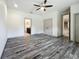 Main bedroom featuring dual closets, bathroom access, and modern gray laminate floors at 5080 Maple Dr, Lakeland, FL 33810