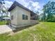 Charming outbuilding with an open air section, stone foundation, and a well-kept lawn, adding character to the property at 5080 Maple Dr, Lakeland, FL 33810