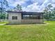 Modern outbuilding with open-air and enclosed spaces, offering flexible uses for storage or hobbies at 5080 Maple Dr, Lakeland, FL 33810