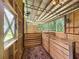 Interior view of outbuilding featuring wood framing, stalls, metal roof, and lighting at 5080 Maple Dr, Lakeland, FL 33810
