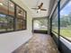 Spacious screened patio featuring brick pavers, ceiling fan, and windows at 5080 Maple Dr, Lakeland, FL 33810