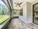 Screened in patio with brick pavers, ceiling fan, and view of the backyard at 5080 Maple Dr, Lakeland, FL 33810