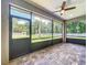 Screened in patio with brick pavers and ceiling fan offering an outdoor living space at 5080 Maple Dr, Lakeland, FL 33810