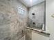 Close up of the gray tiled walk-in shower featuring glass surround and square shower head at 5080 Maple Dr, Lakeland, FL 33810