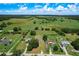 Aerial view showing a wider view of the property and the surrounding farmland and neighborhood at 5268 Rock Dove Loop, Lakeland, FL 33810