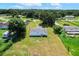 Aerial view of backyard featuring a large grassy lawn and the home's exterior at 5268 Rock Dove Loop, Lakeland, FL 33810