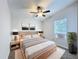 Neutral bedroom features a ceiling fan, window, decorative art, and stylish night stands at 5268 Rock Dove Loop, Lakeland, FL 33810