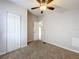 This bedroom features neutral walls, brown carpet, and a double-door closet at 5268 Rock Dove Loop, Lakeland, FL 33810
