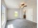 This bedroom has a ceiling fan, neutral paint, carpet, and bright windows at 5268 Rock Dove Loop, Lakeland, FL 33810