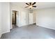 A bright bedroom featuring neutral colors, a ceiling fan, carpet, and multiple doors at 5268 Rock Dove Loop, Lakeland, FL 33810