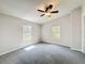 Spacious bedroom with a ceiling fan, carpeting, and a bright window at 5268 Rock Dove Loop, Lakeland, FL 33810