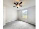 This bedroom features neutral walls, gray carpet, and a ceiling fan with light at 5268 Rock Dove Loop, Lakeland, FL 33810