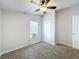 This bedroom features neutral walls, brown carpet, ceiling fan, and window unit at 5268 Rock Dove Loop, Lakeland, FL 33810