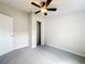 This bedroom features neutral walls, gray carpet, and a ceiling fan with light at 5268 Rock Dove Loop, Lakeland, FL 33810