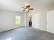This bedroom features neutral walls, a ceiling fan, and a bright window at 5268 Rock Dove Loop, Lakeland, FL 33810