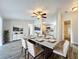 Dining room is bright and spacious with ceiling fan, long table set for six and hardwood floors at 5268 Rock Dove Loop, Lakeland, FL 33810