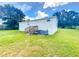 Backyard view of a single-story home showing back entrance and lawn at 5268 Rock Dove Loop, Lakeland, FL 33810