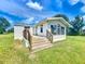 Charming single-story home with a wooden porch and a well-maintained lawn at 5268 Rock Dove Loop, Lakeland, FL 33810