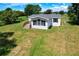 Well-maintained mobile home featuring a cozy front porch and a spacious lawn at 5268 Rock Dove Loop, Lakeland, FL 33810