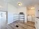 Bright kitchen area with shelving, appliances, wood-look vinyl flooring, and laundry at 5268 Rock Dove Loop, Lakeland, FL 33810