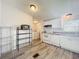 A view of the bright kitchen with appliances, and wood-look vinyl flooring at 5268 Rock Dove Loop, Lakeland, FL 33810
